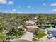 An aerial view of the home displays its well-maintained landscaping and mature trees surrounding the property at 11974 Rosetree S Pl, Seminole, FL 33772