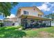 Spacious backyard featuring a screened patio and lush green lawn at 11974 Rosetree S Pl, Seminole, FL 33772
