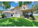 Landscaped backyard with a screened patio and storage shed for convenience at 11974 Rosetree S Pl, Seminole, FL 33772