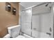 Bright bathroom with a toilet and a tiled shower-tub combination at 11974 Rosetree S Pl, Seminole, FL 33772