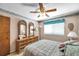 This bedroom includes an ornate dresser, large window and soft decor at 11974 Rosetree S Pl, Seminole, FL 33772