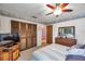 Bedroom featuring a ceiling fan, closet, and dresser at 11974 Rosetree S Pl, Seminole, FL 33772