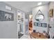 Hallway features decoratively framed pictures, easy access to the laundry room, and natural lighting at 11974 Rosetree S Pl, Seminole, FL 33772