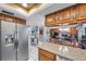 Open concept kitchen with stainless steel refrigerator with easy access to the living and dining spaces at 11974 Rosetree S Pl, Seminole, FL 33772