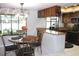 Cozy kitchen featuring wood cabinets, granite countertops, and an adjacent dining area at 11974 Rosetree S Pl, Seminole, FL 33772