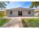 A view of the back of the home, featuring a patio, sliding glass door and two large windows at 12510 Sparkleberry Rd, Tampa, FL 33626