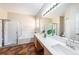 Bright bathroom with double vanity, large mirror, and separate shower and tub at 12510 Sparkleberry Rd, Tampa, FL 33626