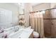 Bathroom featuring single vanity, updated fixtures, and a tiled shower with curtain at 12510 Sparkleberry Rd, Tampa, FL 33626