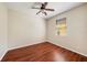 Cozy bedroom features warm wooden floors, a ceiling fan, and natural light from the window at 12510 Sparkleberry Rd, Tampa, FL 33626