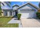 Charming single Gathering home with a two-car garage, arched windows and well-maintained landscaping at 12510 Sparkleberry Rd, Tampa, FL 33626