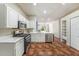 Modern kitchen with stainless steel appliances, white cabinets, and stylish tile flooring at 12510 Sparkleberry Rd, Tampa, FL 33626