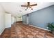 Spacious living room featuring unique flooring and open floorplan with a ceiling fan at 12510 Sparkleberry Rd, Tampa, FL 33626
