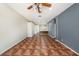 Open-concept living room with unique tile flooring and a ceiling fan at 12510 Sparkleberry Rd, Tampa, FL 33626