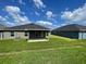 A backyard and covered patio, ideal for outdoor living at 13187 Ogden Glade Rd, Dade City, FL 33525