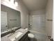 Well-lit bathroom featuring a vanity with a granite countertop and a shower-tub combo at 13187 Ogden Glade Rd, Dade City, FL 33525