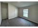 Well-lit bedroom featuring gray carpet, one window, and doors at 13187 Ogden Glade Rd, Dade City, FL 33525
