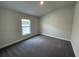 Well-lit bedroom featuring gray carpet and one window at 13187 Ogden Glade Rd, Dade City, FL 33525