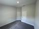 An empty bedroom with gray carpet and two white doors, offering a blank canvas at 13187 Ogden Glade Rd, Dade City, FL 33525