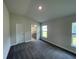 Bedroom with plush carpet, neutral walls, two windows with blinds, and an open doorway to the Primary bathroom at 13187 Ogden Glade Rd, Dade City, FL 33525