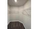 Walk-in closet with carpet and wire shelving for organized storage and functionality at 13187 Ogden Glade Rd, Dade City, FL 33525