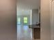 Bright, open-concept living room featuring tile flooring, neutral walls, and plenty of natural light from large windows at 13187 Ogden Glade Rd, Dade City, FL 33525