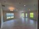 Spacious living room with recessed lighting, tile flooring, neutral walls, and multiple windows for natural light at 13187 Ogden Glade Rd, Dade City, FL 33525