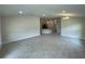 Expansive living area with tile flooring, recessed lights, and open access to kitchen and hallways for easy flow at 13187 Ogden Glade Rd, Dade City, FL 33525