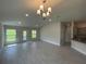 Open living space with tile flooring, neutral walls, recessed lighting, and direct access to kitchen and outdoor areas at 13187 Ogden Glade Rd, Dade City, FL 33525