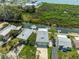 Aerial view of waterfront homes with canal access and boat docks with lifts at 14409 Birch St, Hudson, FL 34667