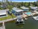 Waterfront home with pool and boat dock, featuring a charming two-story layout and lush surroundings at 14409 Birch St, Hudson, FL 34667