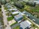 Aerial view of waterfront homes with boat docks and canal access in a quiet neighborhood at 14409 Birch St, Hudson, FL 34667
