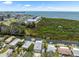 Aerial view of waterfront homes with canal access and beautiful open bay view in the distance at 14409 Birch St, Hudson, FL 34667