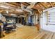 This spacious basement features wooden beams, concrete floors, and an organized workspace, perfect for a variety of hobbies at 14409 Birch St, Hudson, FL 34667