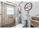 This bathroom boasts a shower with decorative tile and an ocean-themed shower curtain at 14409 Birch St, Hudson, FL 34667