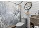 Charming bathroom featuring coastal-themed shower curtain, vanity, and round mirror at 14409 Birch St, Hudson, FL 34667