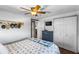 The bedroom features a palm patterned bedspread, wooden floors, and built in storage at 14409 Birch St, Hudson, FL 34667