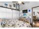 Comfortable bedroom with barn door closet, ceiling fan, and nautical decor at 14409 Birch St, Hudson, FL 34667