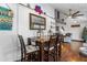 The dining area features a wooden table set for four, with wood floors and a beachy vibe at 14409 Birch St, Hudson, FL 34667