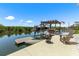 The dock features a boat lift, seating area, and clear views of the peaceful waterway, ideal for outdoor living at 14409 Birch St, Hudson, FL 34667