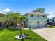 Charming two-story home with a well-manicured lawn and two-car garage at 14409 Birch St, Hudson, FL 34667