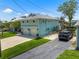 Two-story waterfront home with an attached two-car garage, driveway, and lush lawn at 14409 Birch St, Hudson, FL 34667