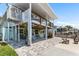 The multi-level exterior with a covered patio offers stunning outdoor living spaces and scenic views, blending comfort and style at 14409 Birch St, Hudson, FL 34667