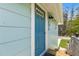 Charming turquoise front door with decorative details and exterior lighting at 14409 Birch St, Hudson, FL 34667