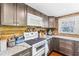 This rustic kitchen features ample storage, modern appliances, and granite countertops at 14409 Birch St, Hudson, FL 34667
