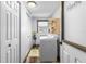 Well-lit laundry room equipped with a washing machine, dryer, and additional storage at 14409 Birch St, Hudson, FL 34667