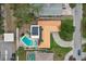 Aerial view shows roof, solar panels, pool, patio furniture, driveway and landscaping at 14564 110Th Ter, Largo, FL 33774