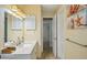 Bright bathroom vanity features a marble countertop, decorative wall art, and access to storage and hallway at 14564 110Th Ter, Largo, FL 33774