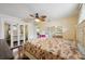 Bright bedroom with hardwood floors, mirrored closet doors, ceiling fan, and light colored walls at 14564 110Th Ter, Largo, FL 33774