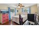 Bedroom with a ceiling fan, wood floors and natural light from two windows at 14564 110Th Ter, Largo, FL 33774
