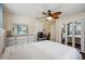 Bedroom with a ceiling fan, wood floors, and large closet with mirrored doors at 14564 110Th Ter, Largo, FL 33774